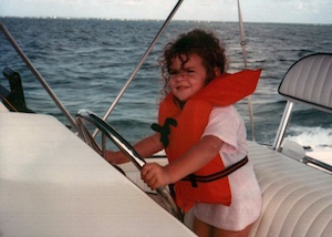 A then-five-year-old Lowe plays captain for the day on the water with her family.
